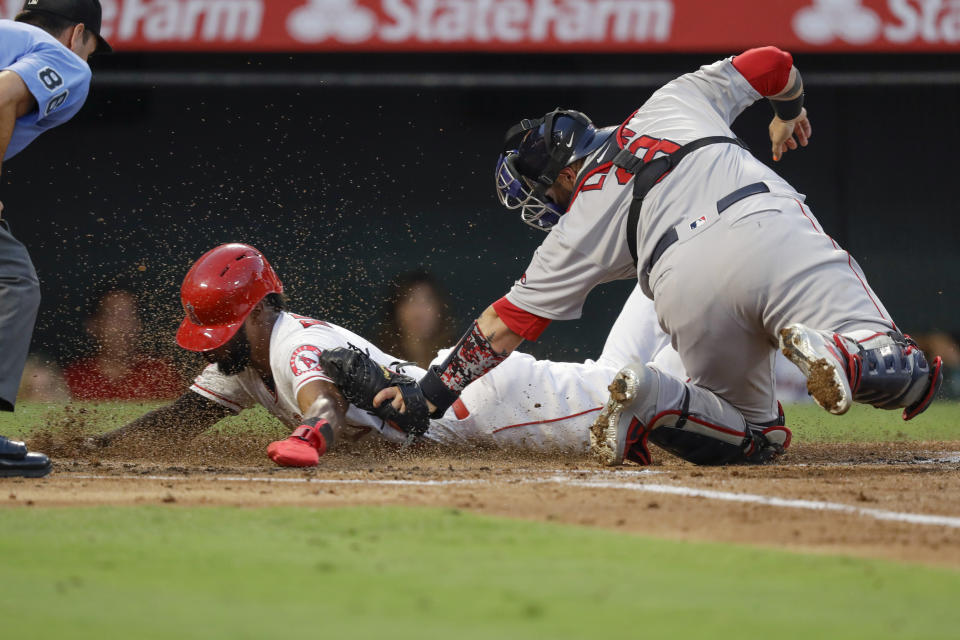 Los Angeles Angels' Luis Rengifo, left, scores past Boston Boston Red Sox catcher Sandy Leon on a single by Mike Trout during the second inning of a baseball game in Anaheim, Calif., Saturday, Aug. 31, 2019. (AP Photo/Chris Carlson)