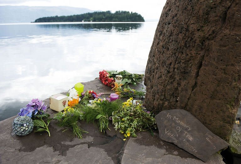 Flowers, candles, and messages are left in honor of the victims of the July 22 shooting spree at a Labour Party youth summer camp on the island of Utoeya. Suspected Norwegian mass killer Anders Behring Breivik faces justice Monday, after Oslo police defended the hour it took to reach the island where most of his 93 victims died in a hail of bullets