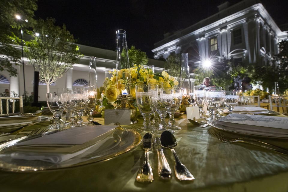 A table is set during a media preview for the State Dinner with President Donald Trump and Australian Prime Minister Scott Morrison in the Rose Garden of the White House, Thursday, Sept. 19, 2019, in Washington. (AP Photo/Alex Brandon)