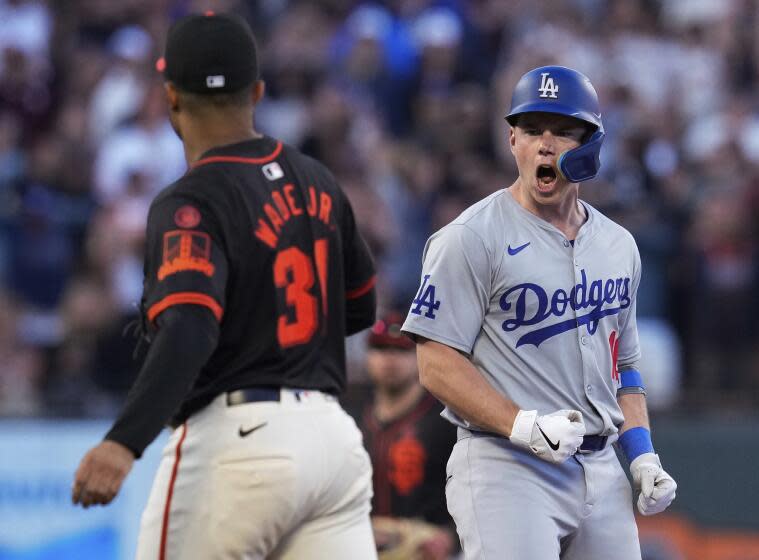 Los Angeles Dodgers' Will Smith, right, reacts after hitting a two-run double against.