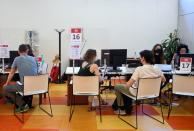 People are seen at an employment centre in Milan