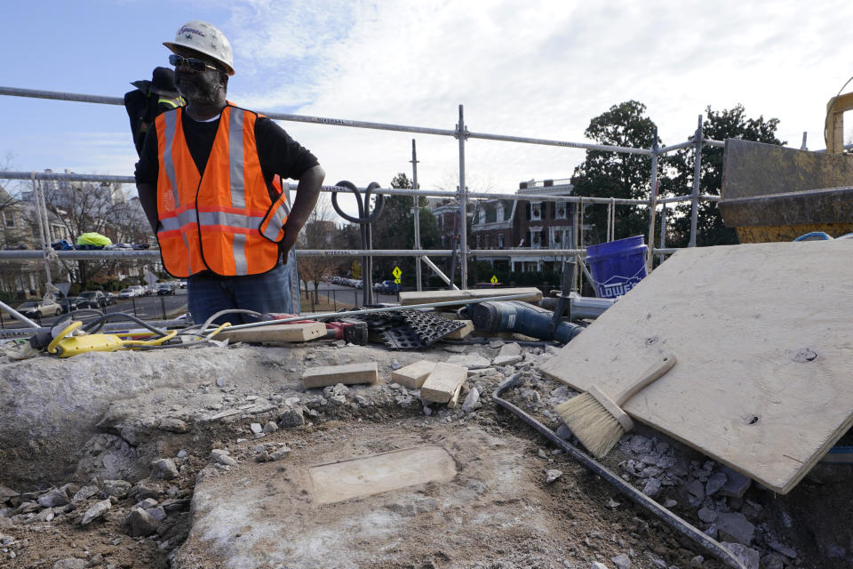 Michael Spence, superintendent for Team Henry construction, looks over a time capsule that was placed in 1887 in the pedestal that once held the statue of Confederate General Robert E. Lee on Monument Avenue, Friday Dec. 17, 2021, in Richmond, Va. Virginia Gov. Ralph Northam ordered the pedestal removed and the land given to the city of Richmond. (AP Photo/Steve Helber)