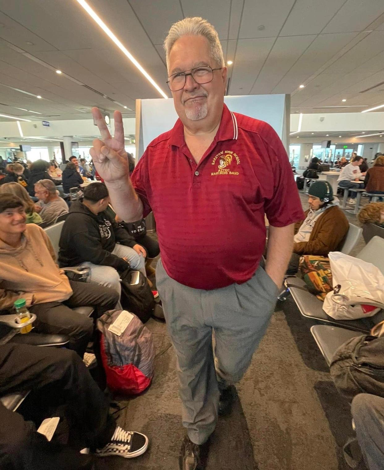 Barstow High School Band Director Dan Barilone waits with the band at Los Angeles International Airport on Monday. The band’s flight from LAX to Texas was eventually canceled, squashing the band’s scheduled performance at the Alamo Bowl on Thursday.