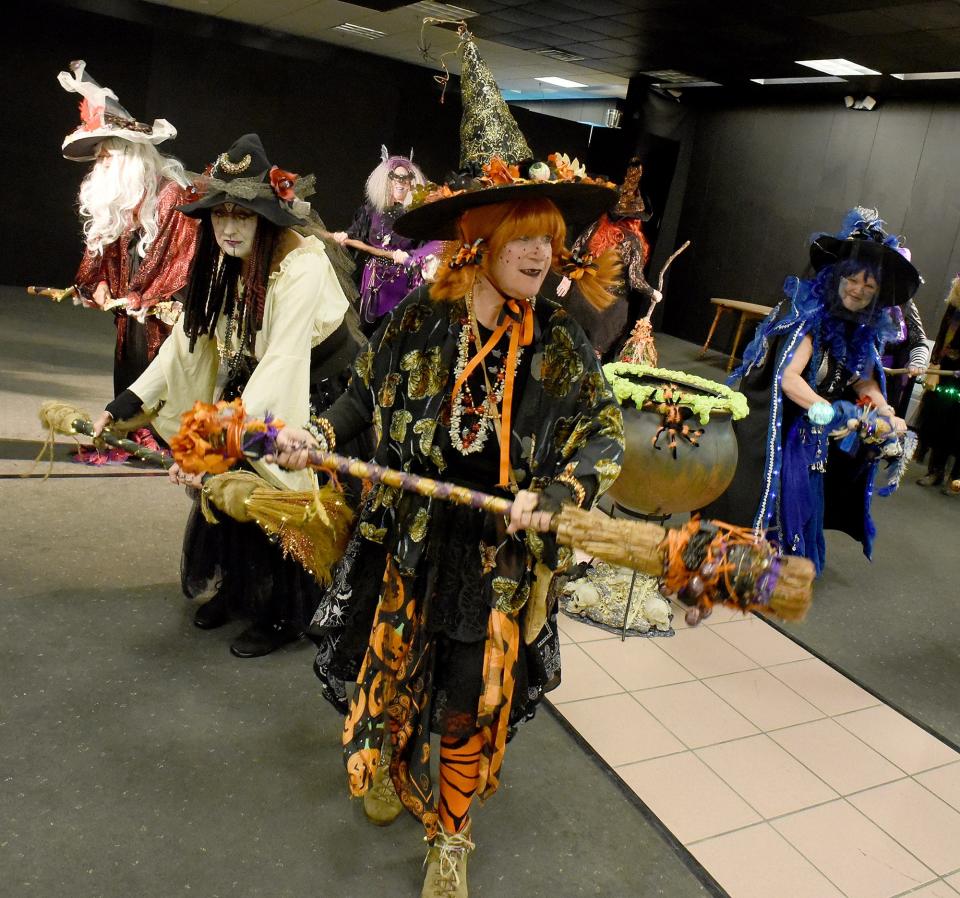 Jackie Rupp, Hollie Milz and Debbie Day (right) of Monroe dance around the cauldron while other members of the Lake Eerie Hexenbrut start to rehearse the witch dance April 30 inside the Players Club at the Mall of Monroe.