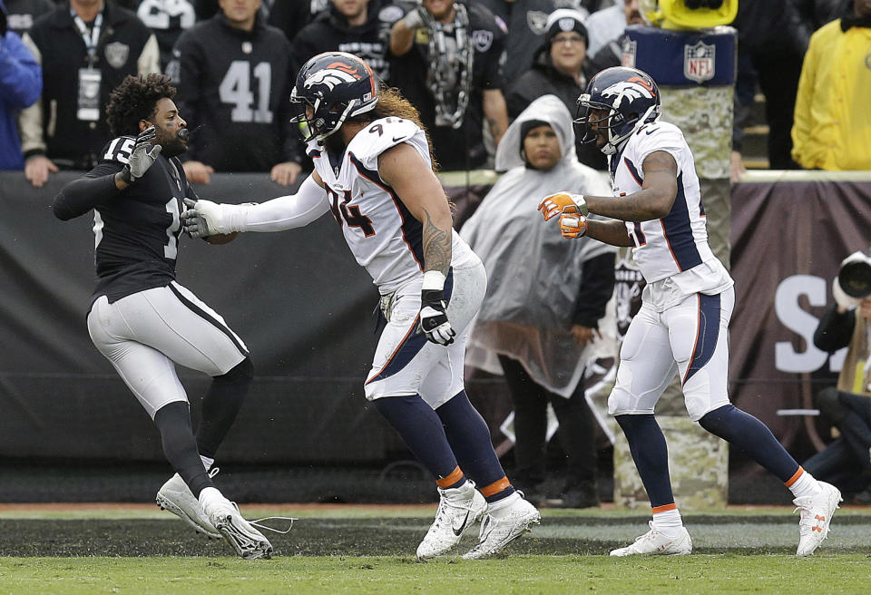 <p>Oakland Raiders wide receiver Michael Crabtree, left, fights with Denver Broncos nose tackle Domata Peko, center, and cornerback Aqib Talib during the first half of an NFL football game in Oakland, Calif., Sunday, Nov. 26, 2017. Crabtree and Talib were ejected. (AP Photo/Ben Margot) </p>