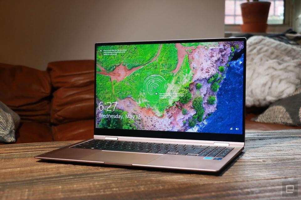 Samsung Galaxy Book Pro 360 review pictures. Off-angle front view of the 15-inch Galaxy Book Pro 360 on a table in front of a brown couch.