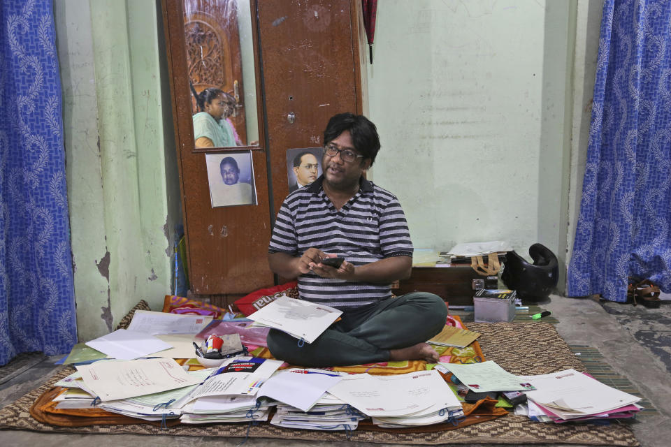 Gharu Bhatti, an activist working for the welfare of lower caste Hindus, shows his paperwork in Jammu, India, July 30, 2020. A year after India ended disputed Kashmir's semi-autonomous status and downgraded it to a federally governed territory, authorities have begun issuing residency and land ownership rights to outsiders for the first time in almost a century. Bhatti said that the domicile law ended their "slavery." Bhatti's parents were among some 270 sanitation workers brought by the government to Jammu from neighboring Punjab state in 1957. Since then, their numbers have grown to nearly 7,000, said Bhatti, who is among the first few dozen from his community to get the region's residency. Documents accessed and reviewed by The Associated Press show at least 60,000 have gained residency in the last two months including Hindu refugees, Gurkha soldiers and bureaucrats. (AP Photo/Channi Anand)