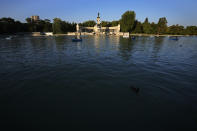 People row pleasure boats in the lake in front of the monument to King Alfonso XII in the Retiro park in Madrid, Spain, Friday, July 23, 2021. Madrid's tree-lined Paseo del Prado boulevard and the adjoining Retiro park have been added to UNESCO's World Heritage list. The UNESCO World Heritage Committee backed the candidacy that highlighted the green area's introduction of nature into Spain's capital. (AP Photo/Paul White)