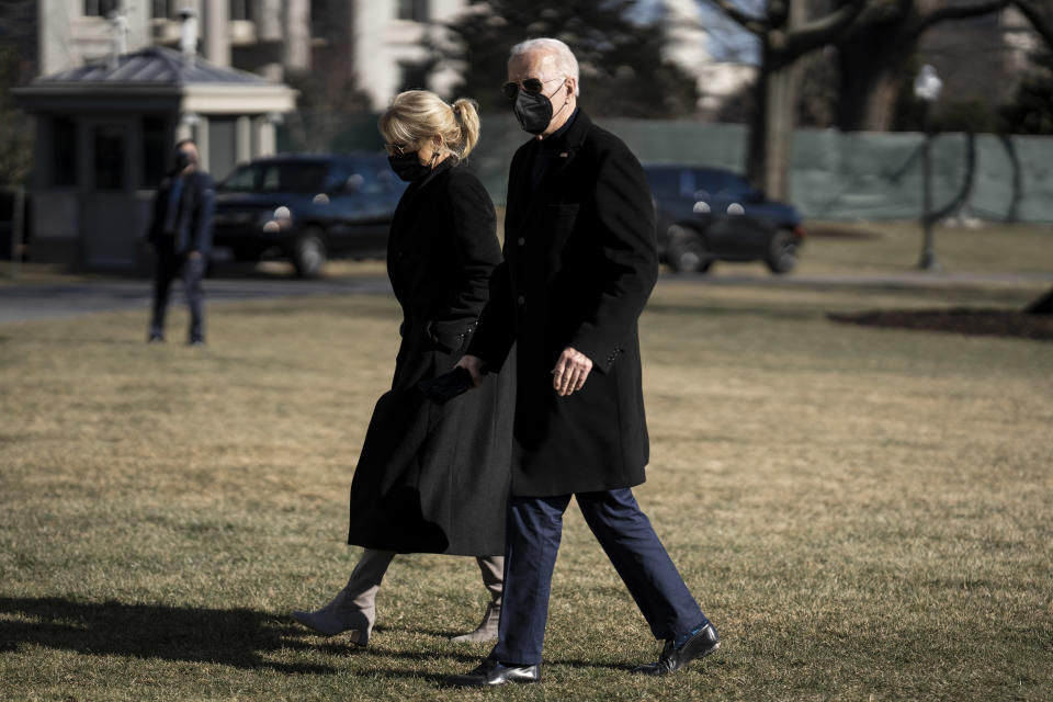 President Biden and first lady Jill Biden walk on the South Lawn of the White House.