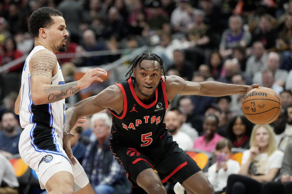 Orlando Magic guard Cole Anthony, lefrt, fouls Toronto Raptors guard Immanuel Quickley (5) during the first half of an NBA basketball game Friday, March 15, 2024, in Toronto. (Frank Gunn/The Canadian Press via AP)