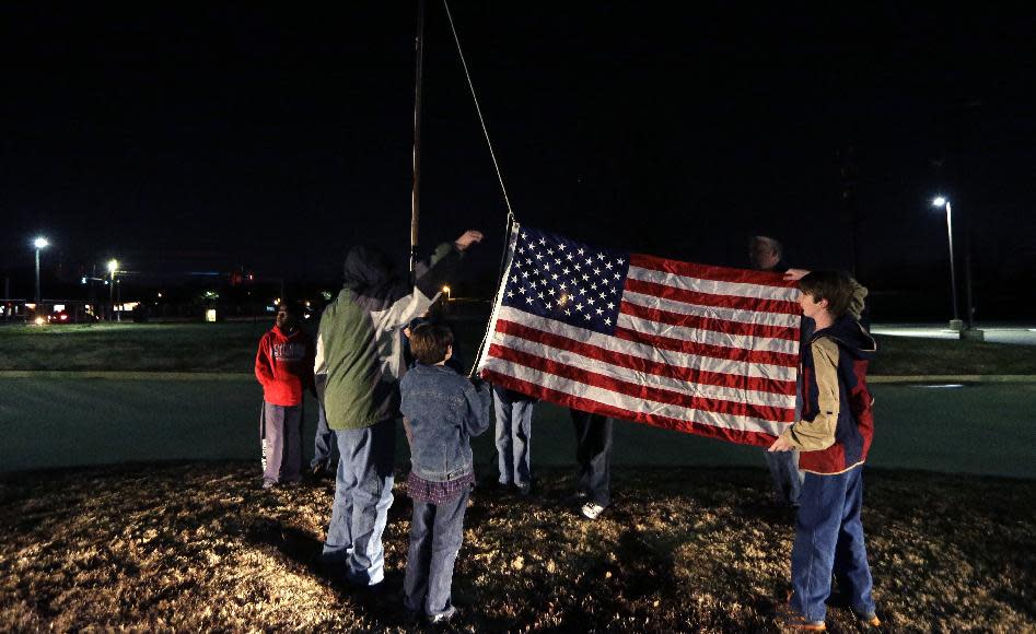 In this Tuesday, Feb. 4, 2014 photo, Trail Life members practice a flag raising ceremony during a nighttime meeting in North Richland Hills, Texas. Trail Life USA promotes itself on its website as the "premier national character development organization for young men which produces Godly and responsible husbands, fathers and citizens." (AP Photo/LM Otero)