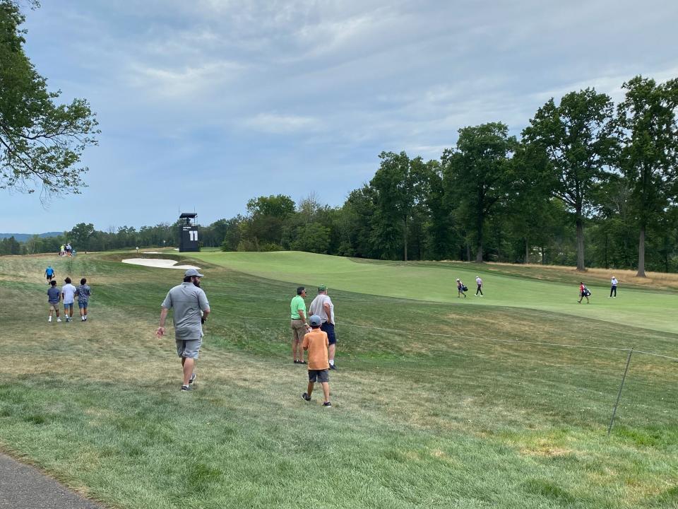 Peter and Tom cheer on golfers on one of the more sparsely populated holes.