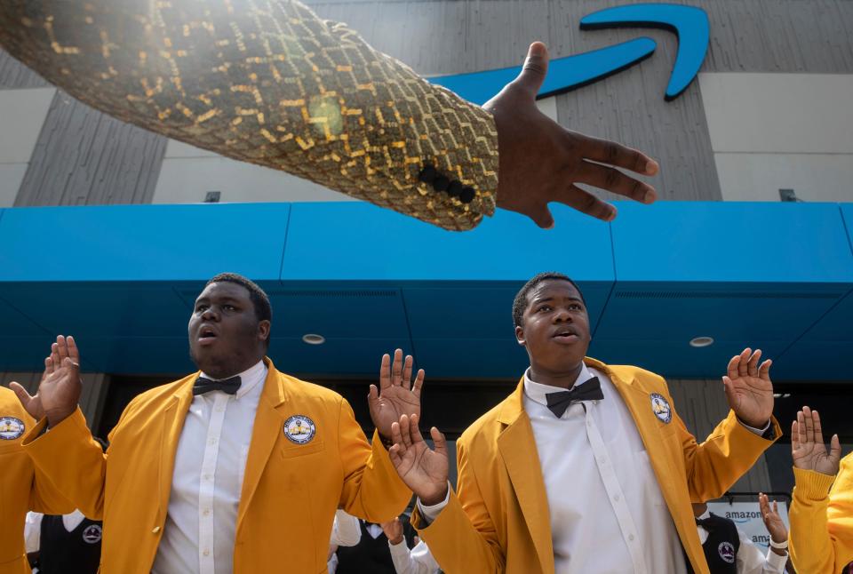 The Detroit Youth Choir members, Brandon Hill, left, and  Javaughn Williams, perform alongside the other choir members during a ribbon-cutting ceremony at the new Amazon Fulfillment Center in Detroit on Wednesday, July 26, 2023. 