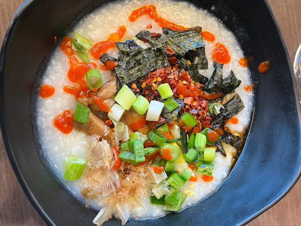 bowl of congee with lots of toppings on an alaskan cruise ship