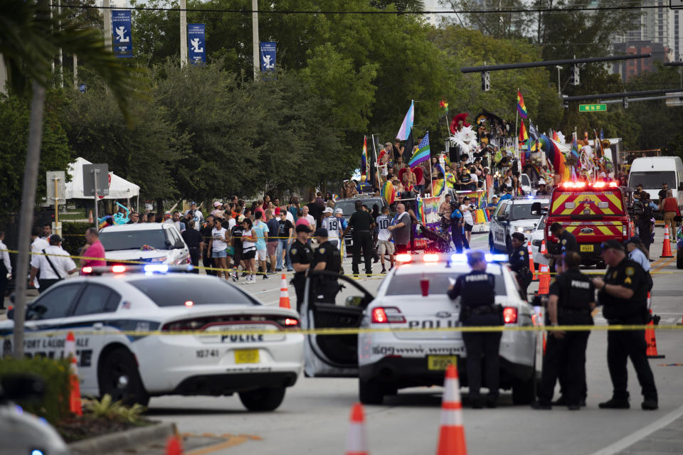 Police and firefighters respond after a truck drove into a crowd of people injuring them during The Stonewall Pride Parade and Street Festival in Wilton Manors, Fla., on Saturday, June 19, 2021. WPLG-TV reports that the driver of the truck was taken into custody. (Chris Day/South Florida Sun-Sentinel via AP)