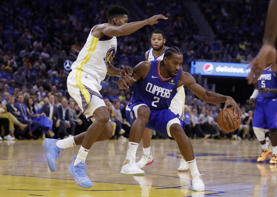 Los Angeles Clippers' Kawhi Leonard (2) drives the ball against Golden State Warriors' Glenn Robinson III, left, during the first half of an NBA basketball game Thursday, Oct. 24, 2019, in San Francisco. (AP Photo/Ben Margot)