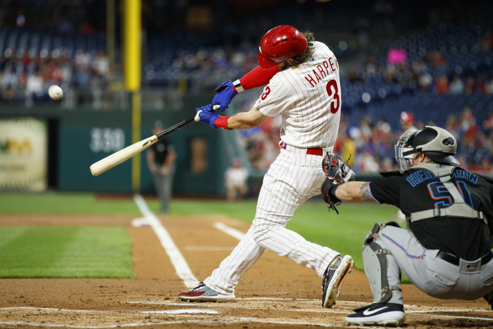 Philadelphia Phillies' Bryce Harper (3) hits an RBI-triple off Miami Marlins starting pitcher Pablo Lopez during the first inning of a baseball game, Friday, Sept. 27, 2019, in Philadelphia. (AP Photo/Matt Slocum)