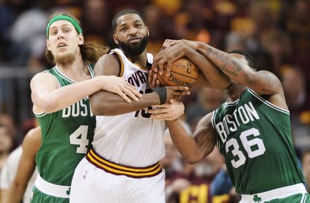 May 21, 2017; Cleveland, OH, USA; Cleveland Cavaliers center Tristan Thompson (13) fights for possession with Boston Celtics center Kelly Olynyk (41) and guard Marcus Smart (36) during the first half in game three of the Eastern conference finals of the NBA Playoffs at Quicken Loans Arena. Mandatory Credit: Ken Blaze-USA TODAY Sports