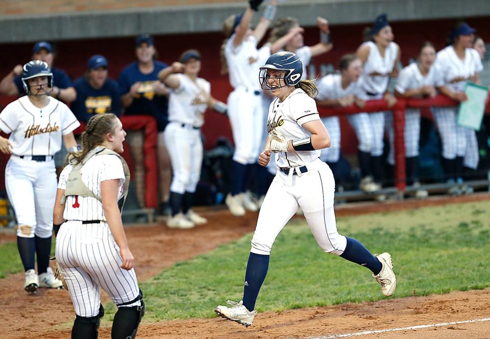 Hillsdale High School's Isabella Dalton (22) celebrates as she scores on a ball hit by Taylor Morgan in the sixth inning during their OHSAA Division IV District Championship game Thursday, May 19, 2022 at Akron Firestone Stadium. Hillsdale won the game 6-3. TOM E. PUSKAR/TIMES-GAZETTE.COM