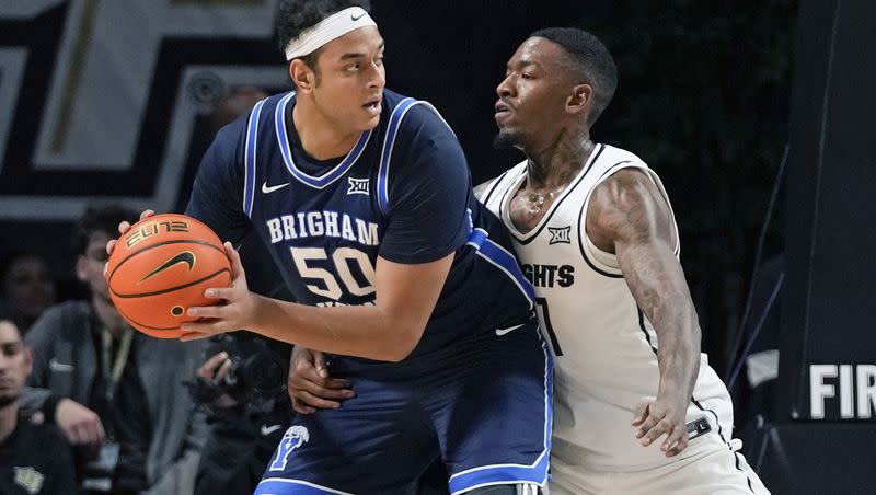BYU center Aly Khalifa (50) looks fro a way around Central Florida forward C.J. Walker during the first half of an NCAA college basketball game, Saturday, Jan. 13, 2024, in Orlando, Fla. (AP Photo/John Raoux)