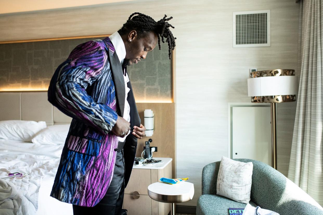 Missouri defensive lineman Darius Robinson puts on his custom made jacket as he prepares for the red carpet event before the NFL draft in Detroit on Thursday, April 25, 2024.