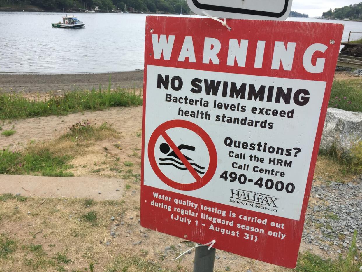 This sign at Albro Lake Beach on Thursday, Aug. 3, 2017, warns of bacteria levels that exceed health standards. (Paul Palmeter/CBC - image credit)