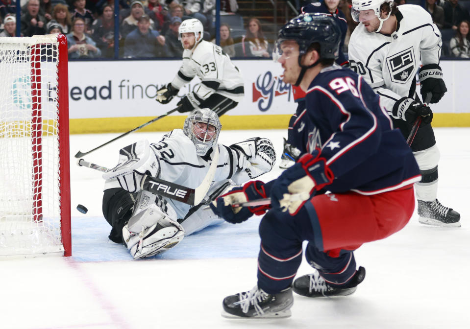 Columbus Blue Jackets forward Jack Roslovic, right, scores past Los Angeles Kings goalie Jonathan Quick during the second period of an NHL hockey game in Columbus, Ohio, Sunday, Dec. 11, 2022. (AP Photo/Paul Vernon)