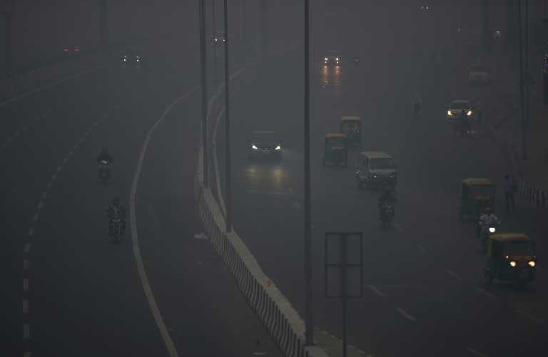 Commuters travel amid heavy smog in New Delhi after a night of free-for-all Diwali fireworks