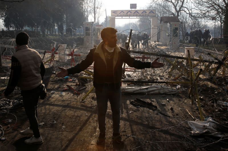 Migrant gestures at Turkey's Pazarkule border crossing with Greece's Kastanies, in Edirne