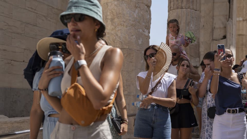 Tourists visit the ancient Acropolis hill during a heat wave in Athens, Greece, on July 21. - Petros Giannakouris/AP