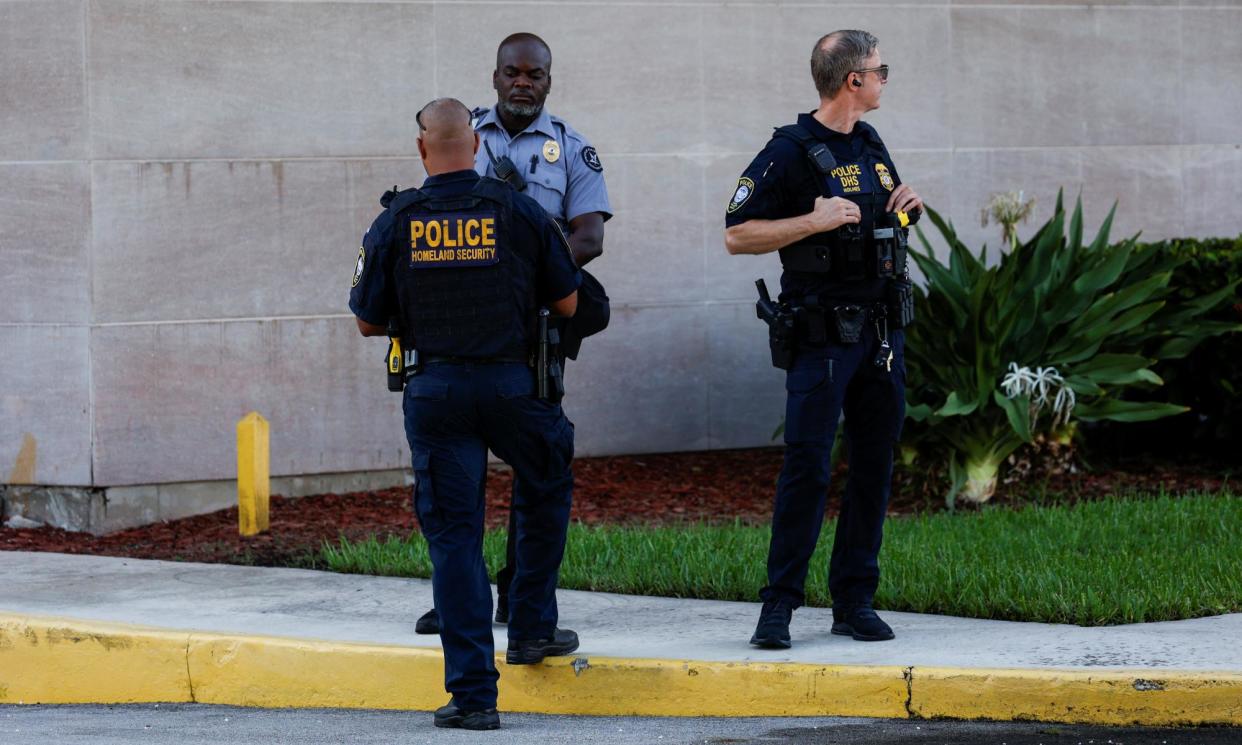 <span>Police officers stand outside the federal courthouse in West Palm Beach, Florida.</span><span>Photograph: Marco Bello/Reuters</span>