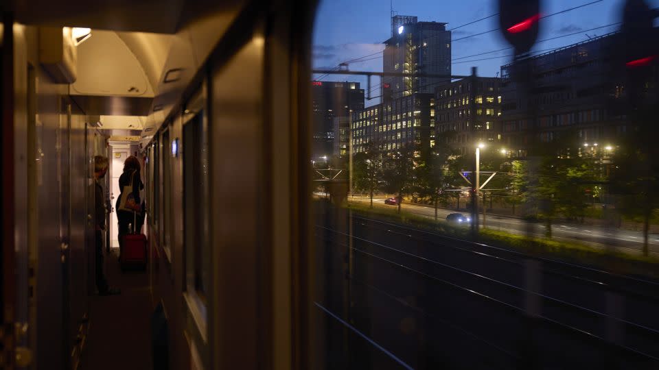A passenger heads to her cabin on board the Good Night Train service, operated by European Sleeper, as it departs Amsterdam. The success or failure of a new, no-frills night train service from Brussels to Berlin could set a precedent for future startup routes. - Ksenia Kuleshova/Bloomberg/Getty Images