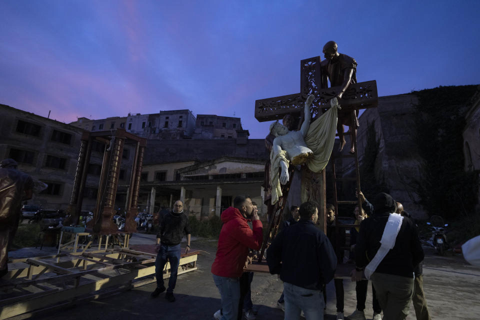 Artisans assemble a "Mistero", a float depicting a biblical scene in the courtyard of the former prison of Procida Island, Italy, early Friday, March 29, 2024. Italy is known for the religious processions that take over towns big and small when Catholic feast days are celebrated throughout the year. But even in a country where public displays of popular piety are a centuries-old tradition, Procida's Holy Week commemorations stand out. (AP Photo/Alessandra Tarantino)