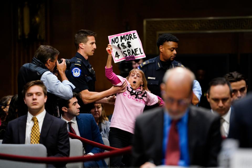 U.S. Capitol Police officers remove a protester from a hearing as Secretary of State Antony Blinken and Defense Secretary Lloyd Austin testify before the Senate Appropriations Committee on Tuesday, Oct. 31, 2023 in Washington, D.C.