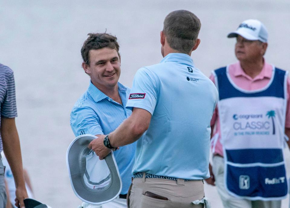 Golfer Bud Cauley shakes hands with Peter Malnati after he birdied 18th hole to take the lead in the second round of The Cognizant Classic in The Palm Beaches at PGA National Resort & Spa on March 1, 2024 in Palm Beach Gardens, Florida.