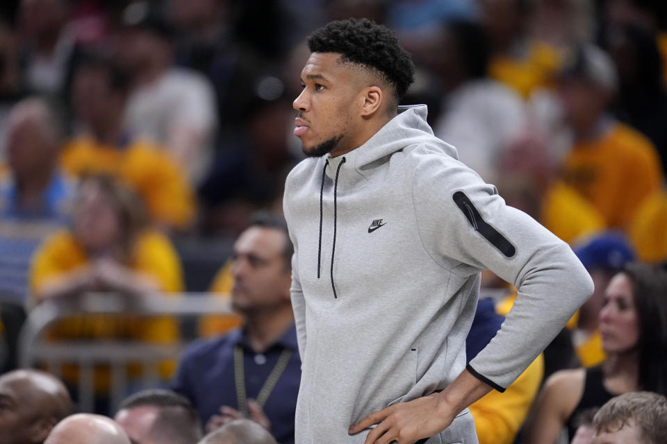 Milwaukee Bucks forward Giannis Antetokounmpo watches from the bench during the first half against the Indiana Pacers in Game 6 in an NBA basketball first-round playoff series, Thursday, May 2, 2024, in Indianapolis. (AP Photo/Michael Conroy)