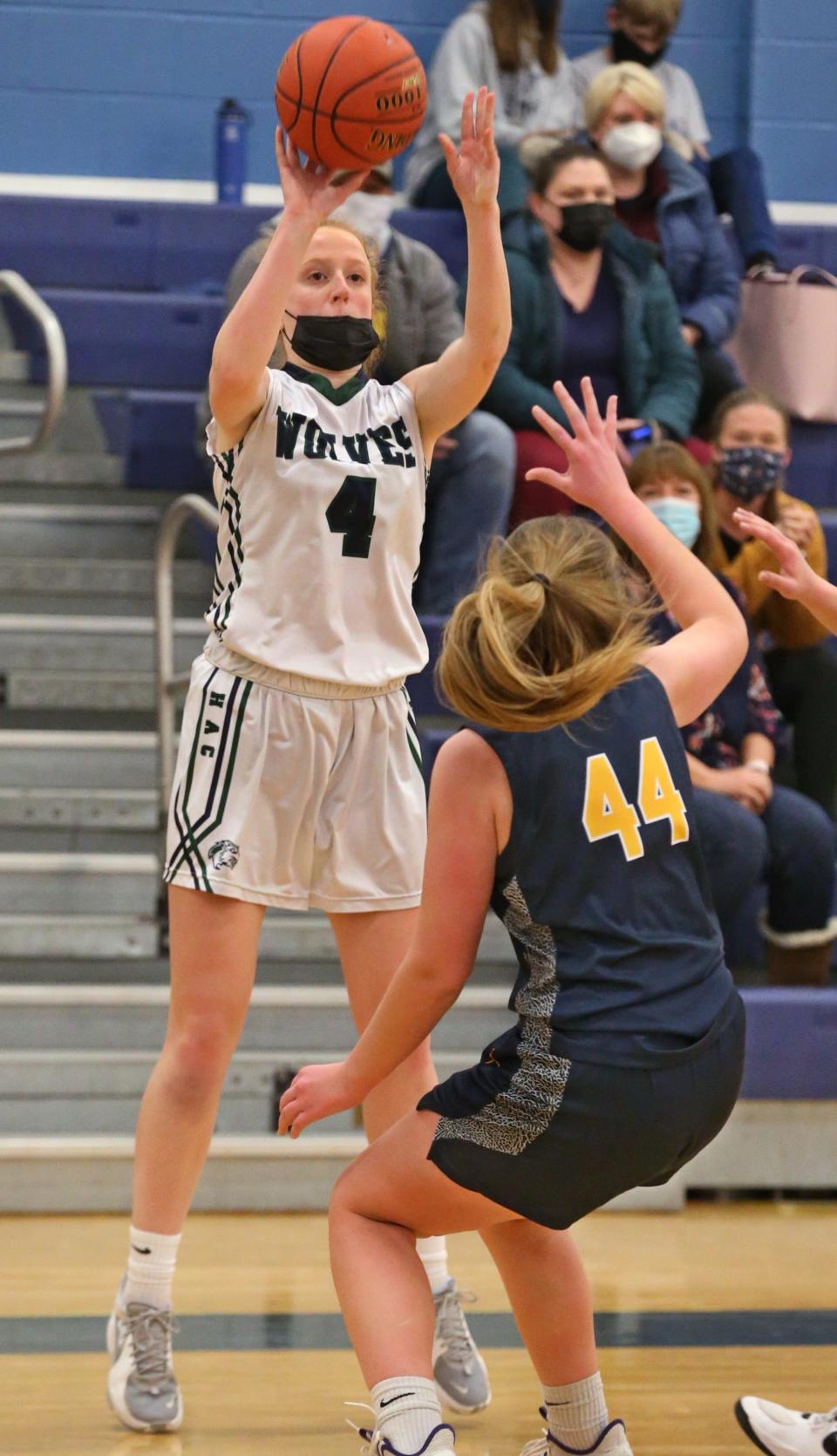 HAC's Eliza Nicosia (4), left, puts up a three point shot over Whitman's Katie Bootes (44), right, during their game at Allendale Columbia School in Pittsford Monday, Feb. 7, 2022.