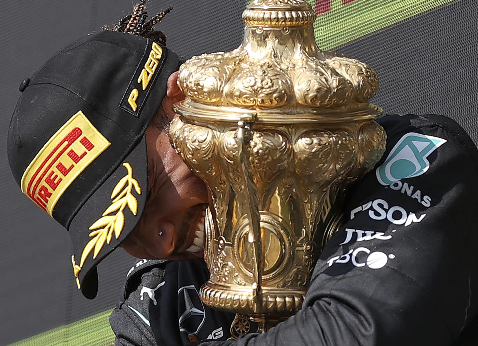 Mercedes driver Lewis Hamilton of Britain celebrates on the podium after winning the British Formula One Grand Prix, at the Silverstone circuit, in Silverstone, England, Sunday, July 18, 2021. (Lars Baron/Pool photo via AP)