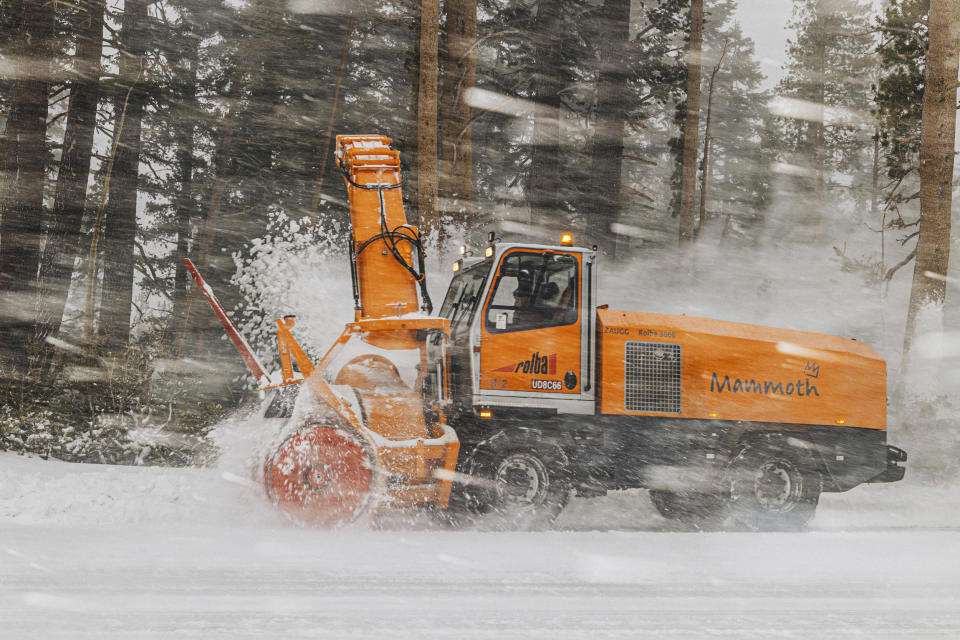 In this photo provided by Mammoth Mountain Ski Area, a snowplower removes snow in Mammoth Mountain in Mammoth Lakes, Calif., on Friday, April 15, 2022. California storms have blanketed the Sierra Nevada in snow. Winter isn't quite ready to give up its grip on the Eastern Sierra. Mammoth Mountain is expecting a foot of fresh snow Saturday. (Peter Morning/MMSA via AP)