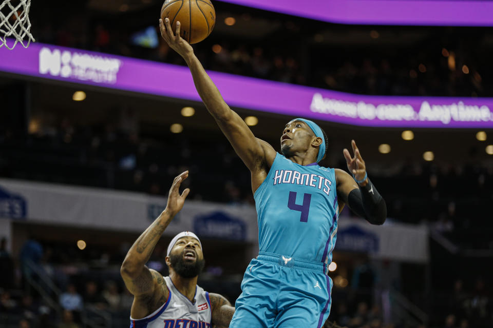 Charlotte Hornets guard Devonte' Graham (4) drives to the basket against Detroit Pistons forward Markieff Morris in the first half of an NBA basketball game in Charlotte, N.C., Friday, Nov. 15, 2019. Charlotte won 109-106. (AP Photo/Nell Redmond)