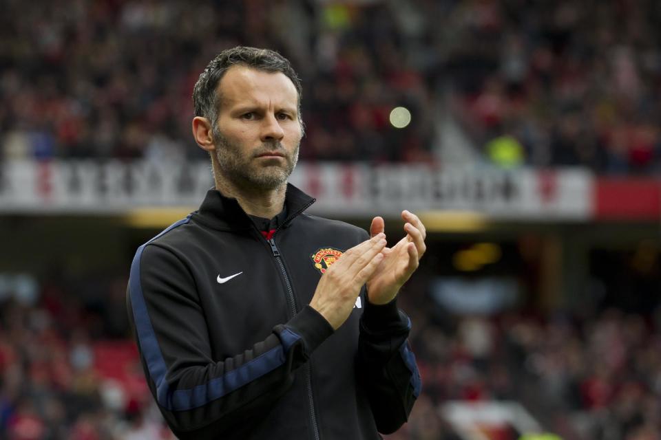 Manchester United's interim manager Ryan Giggs applauds before his team's English Premier League soccer match against Hull at Old Trafford Stadium, Manchester, England, Tuesday, May 6, 2014. (AP Photo/Jon Super)