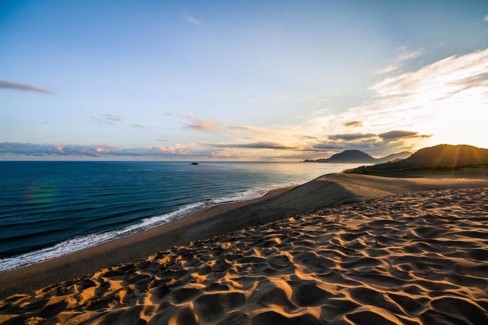 Tourists are defacing ancient sand dunes in Japan with graffiti messages.The Tottori Sand Dunes, a major attraction in southern Japan, has introduced signs in Chinese, English and Korean at the five entrances in a bid to stop the “sand graffiti”.The 100,000-year-old sand dunes are considered a “natural park”, which means vandalism of the landscape is forbidden.In the last decade, there were more than 3,000 incidents of vandalism in the park. Some 228 cases were recorded in 2018 alone, up from 200 the year before.There have been several high-profile examples of vandalism.This January, a 5 metre-high, 25 metre-wide message reading “Happy Birthday Natalie” was left scrawled across a dune, while in April the name “Sebastian” was found alongside the drawing of a face, according to local media.Both pieces of graffiti were removed by local government.Tottori prefecture received more than 3 million overnight visitors last year, an increase of 30 per cent since 2009. Foreign visitors make up half of that number, officials estimate.Local official Tomihisa Ikeuchi told Mainichi Shimbun: “We are concerned about whether the rules are fully understood, but we want to continue to protect views of the beautiful sand dunes.”