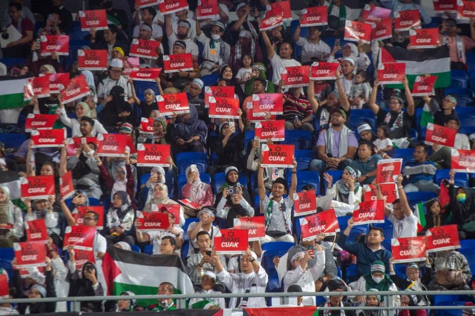 People hold placards during the Solidarity with Palestine rally at Axiata Arena, Kuala Lumpur on October 24, 2023. ― Picture by Shafwan Zaidon