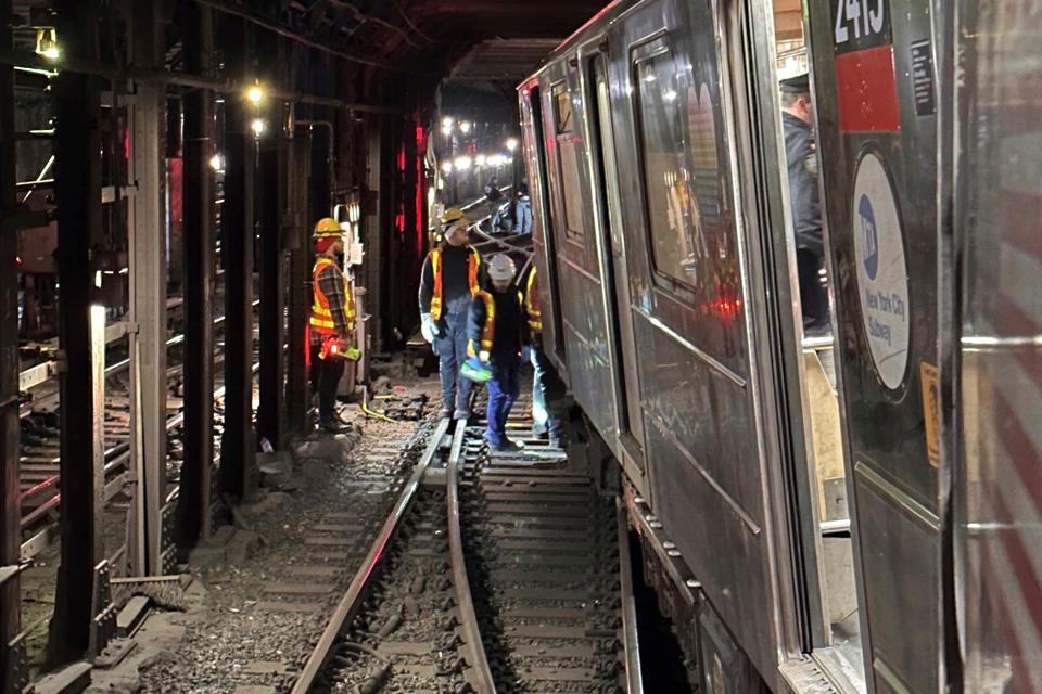 This photo provided by NYC Emergency Management shows the derailment of a New York City subway car, Thursday, Jan. 4, 2024. A New York City subway train derailed Thursday after being sideswiped by another train, leaving more than 20 people with minor injuries including some who were brought to hospitals, the New York City Police Department said. (NYC Emergency Management via AP)