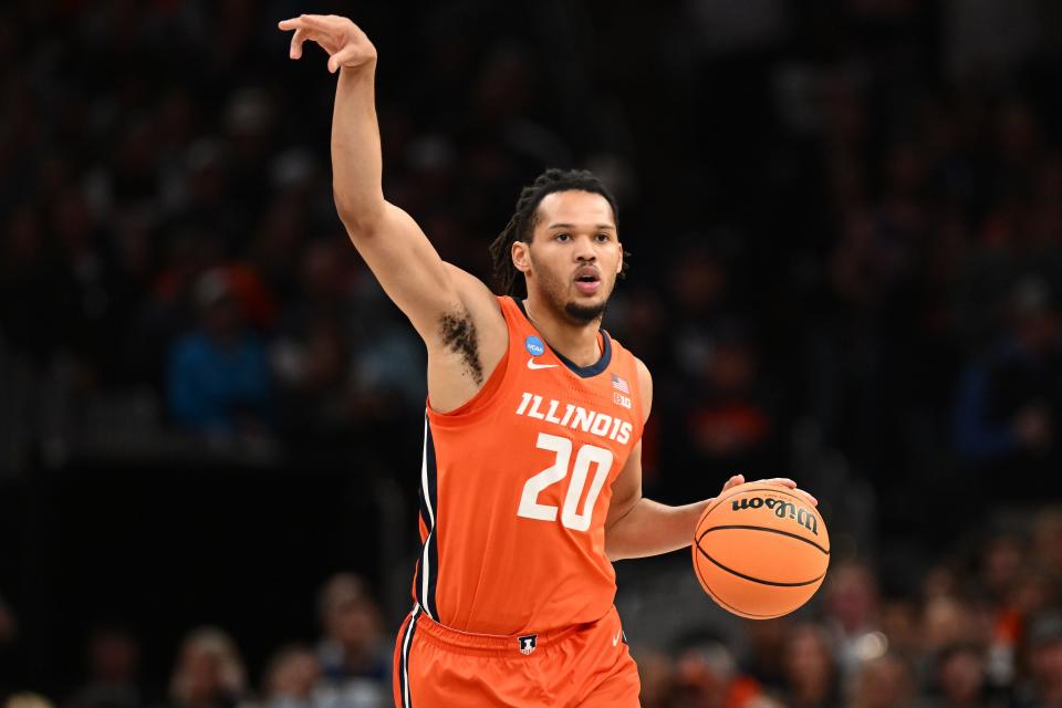 Mar 30, 2024; Boston, MA, USA; Illinois Fighting Illini forward Ty Rodgers (20) dribbles the ball against the Connecticut Huskies in the finals of the East Regional of the 2024 NCAA Tournament at TD Garden. Mandatory Credit: Brian Fluharty-USA TODAY Sports