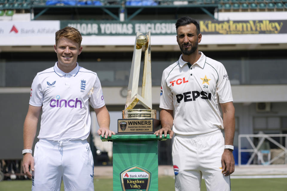 Pakistan's test team skipper Shan Masood, right, and his England's counterpart Ollie Pope pose for photograph with test series trophy, in Multan, Pakistan, Sunday, Oct. 6, 2024. (AP Photo/Anjum Naveed)