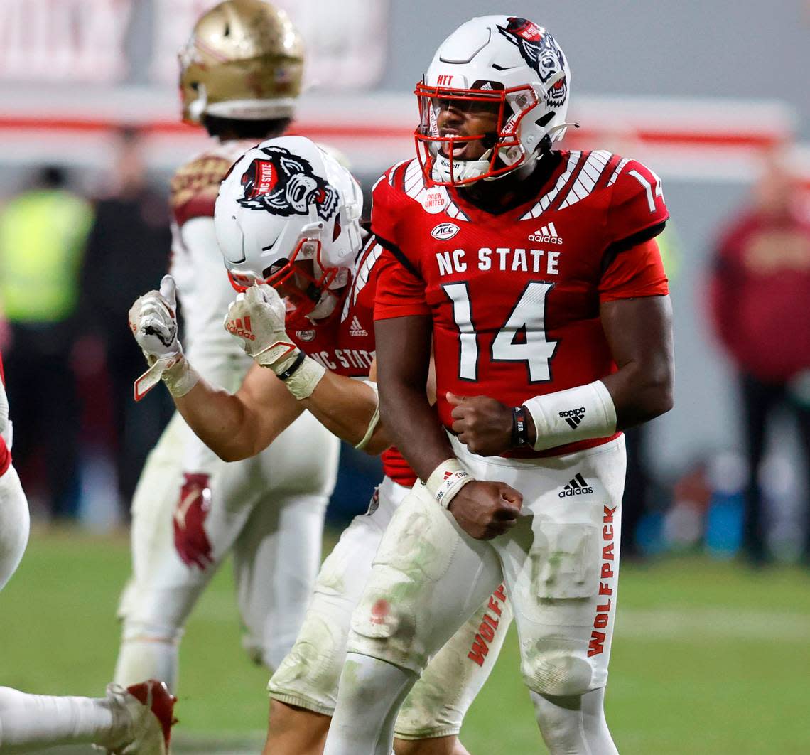 N.C. State quarterback Jack Chambers (14) and Jordan Houston (3) celebrate as time runs out during N.C. State’s 19-17 victory over Florida State at Carter-Finley Stadium in Raleigh, N.C., Saturday, Oct. 8, 2022.