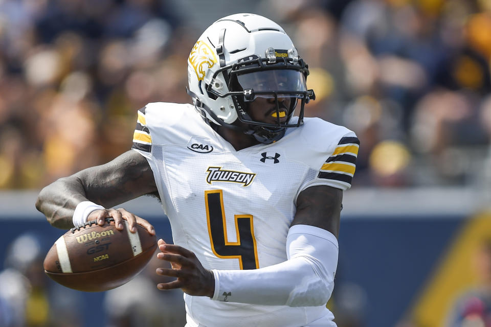 Towson quarterback Tyrrell Pigrome (4) makes a pass against West Virginia during the first half of an NCAA college football game in Morgantown, W.Va., Saturday, Sept. 17, 2022. (AP Photo/William Wotring)