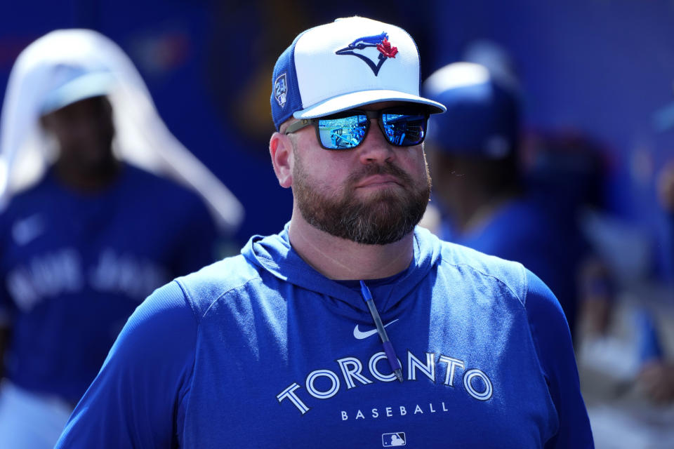 Toronto Blue Jays manager John Schneider stands in the duguout before a spring training baseball game against the Philadelphia Phillies Monday, March 4, 2024, in Dunedin, Fla. (AP Photo/Charlie Neibergall)