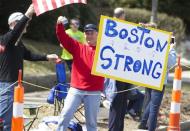 Apr 21, 2014; Boston, MA, USA; A man holds up a Boston Strong poster along the race course during the 2014 Boston Marathon. David Butler II-USA TODAY Sports